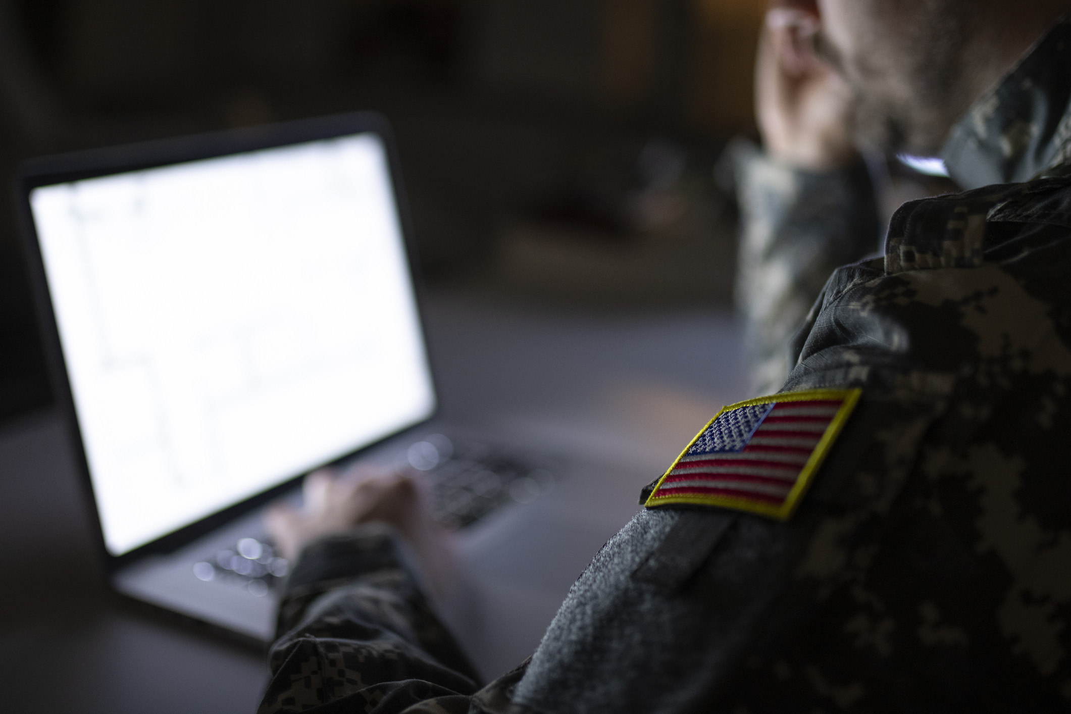 A U.S. military solider using a computer.