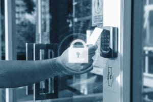 Someone scanning a key card to gain access to a building. Learn about the benefits of having a security clearance.