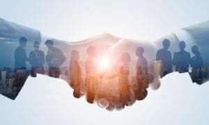 A handshake signifying that Sentient Digital, Inc. acquires DoD contractor, RDA, Inc.