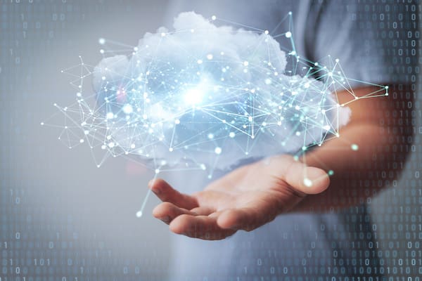 A cloud migration case study symbolized by a person holding a cloud with data in their hand