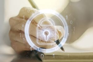 FSO Certification depicted as a hand writing with a transparent image of a lock superimposed over it