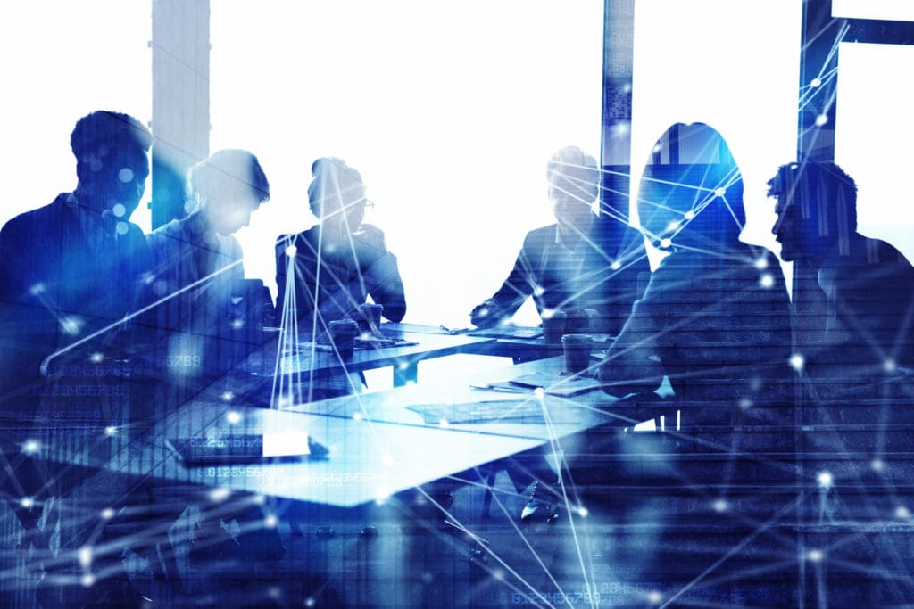Tech Company Culture represented by blue silhouettes of people at a conference table with an overlay of connected line segments