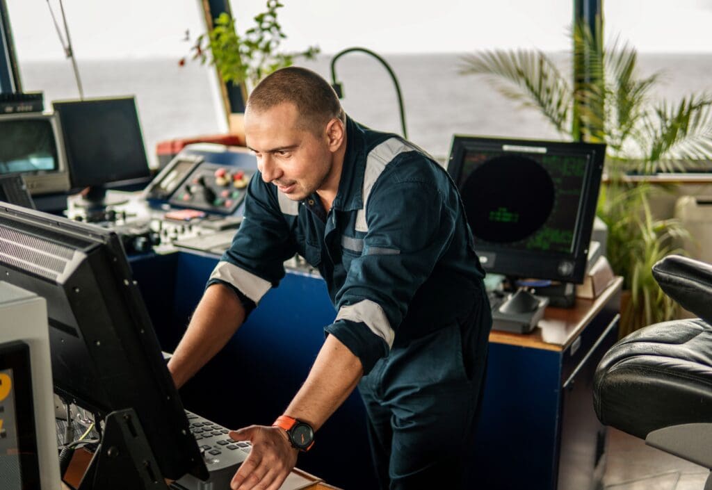 Marine navigation officer looking at navigation systems.